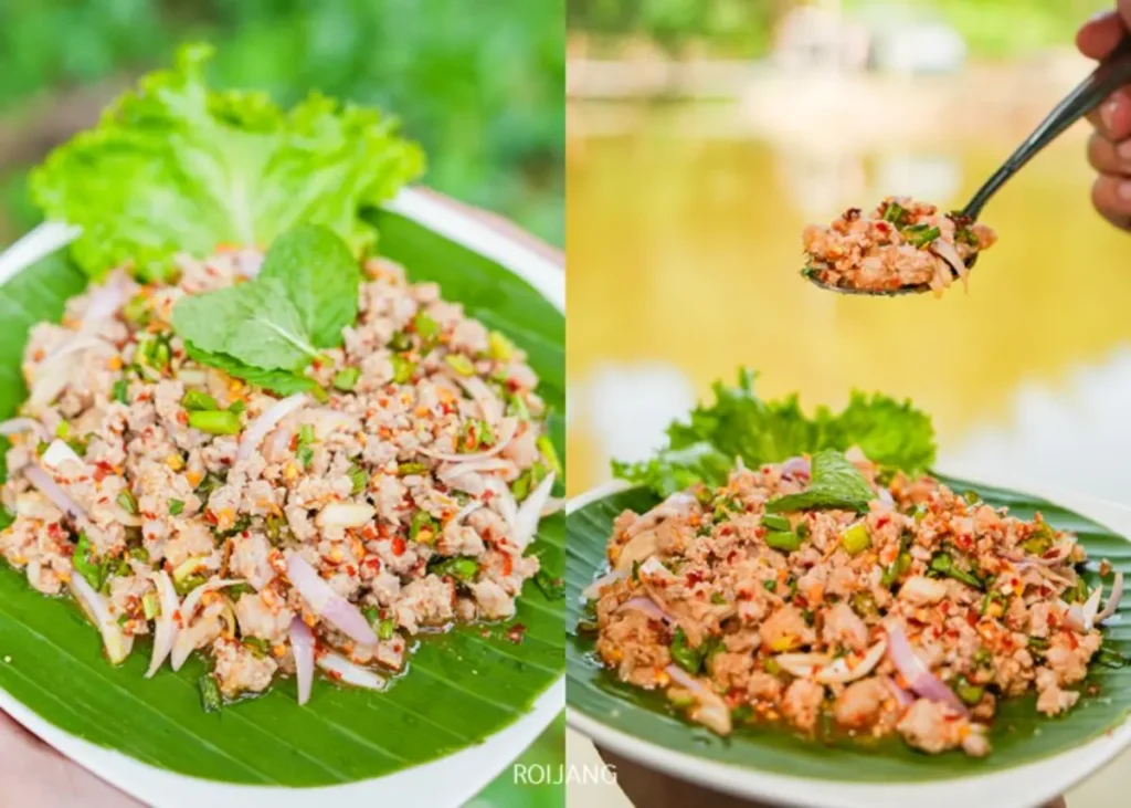 จานสลัดเนื้อสับกับสมุนไพรและหัวหอมเสิร์ฟบนใบตอง ตกแต่งด้วยผักกาดหอมและสะระแหน่ รับประทานกลางแจ้งในอากาศบริสุทธิ์ของหุบเขาหมอกพร้อมวิวทิวทัศน์อันงดงาม.