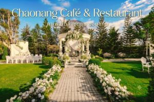 การจัดงานแต่งงานกลางแจ้งที่ร้านชาวนาง คาเฟ่ & ร้านอาหาร ประกอบด้วยศาลาสีขาว การตกแต่งด้วยดอกไม้ และการจัดที่นั่งบนสนามหญ้าสีเขียวพร้อมต้นไม้เป็นฉากหลัง.
