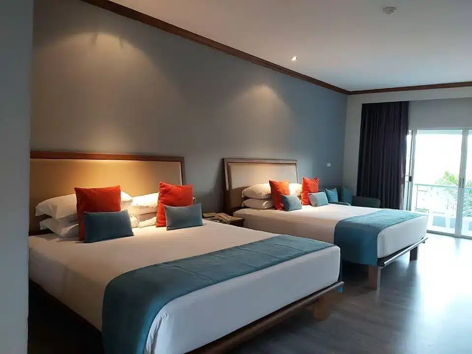 ห้องพักในโรงแรม ที่พักสระบุรีริมน้ำ ที่มีสองเตียงและระเบียง