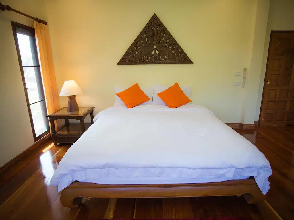โรงแรมภูเก็ตพร้อมเตียงสีขาวและหมอนสีส้ม ที่พักด่านช้าง