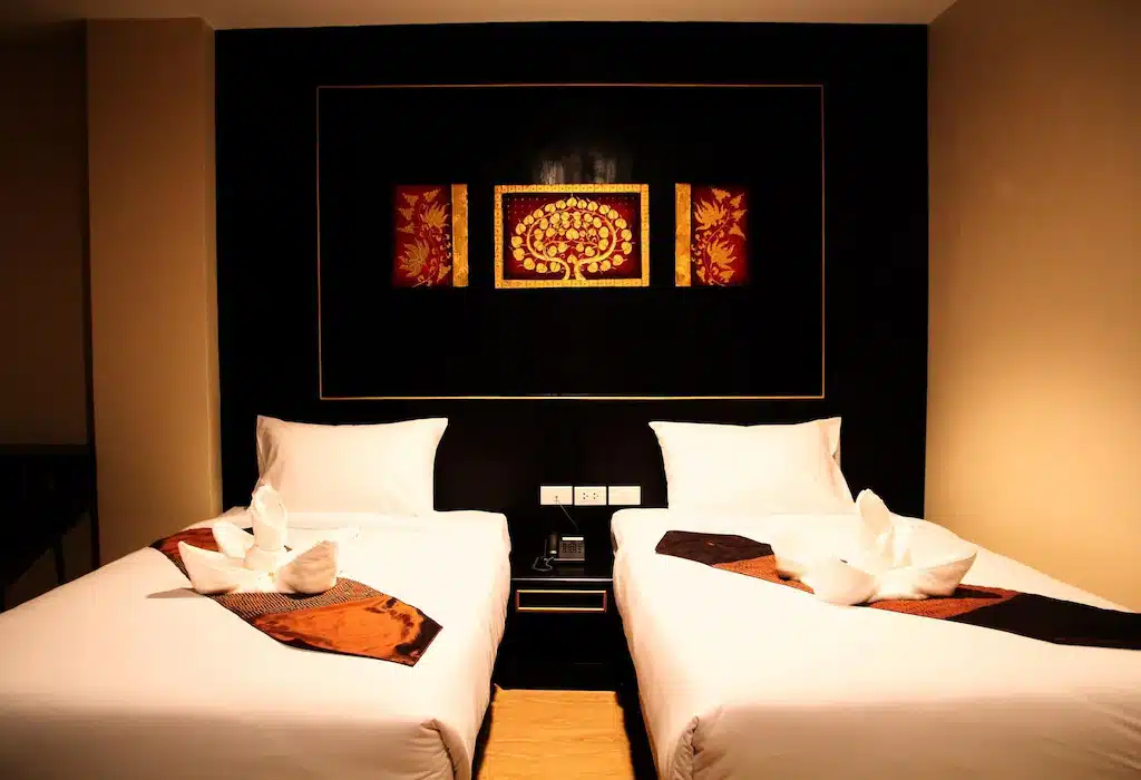 โรงแรมทุ่งสง กับสองเตียงในห้องที่ประดับด้วยภาพวาดบนฝาผนัง
