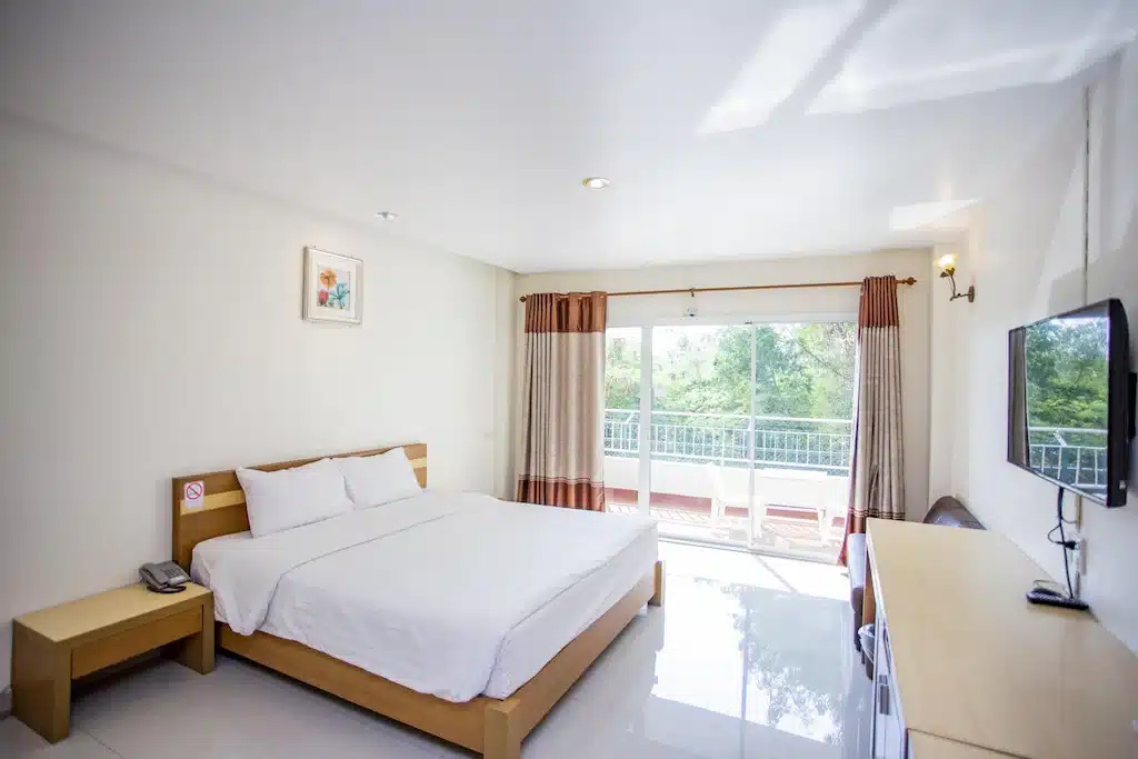 ห้องพักในโรงแรมพร้อมเตียงและระเบียง ที่เที่ยวสิงห์บุรี ที่เที่ยวสิงห์บุรี
