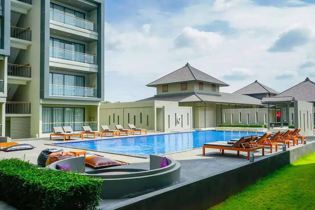 สระว่ายน้ำและเก้าอี้นั่งเล่นหน้าอาคารอพาร์ตเมนต์ ที่เที่ยวปราจีนบุรี