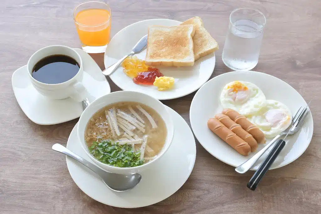 อาหารเช้าจานหนึ่งพร้อมไข่และไส้กรอกบนโต๊ะไม้ ผาแต้ม 