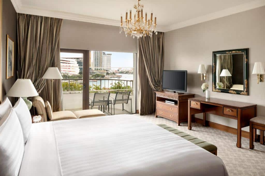 ห้องพักในโรงแรมที่มีเตียงขนาดใหญ่และระเบียงในราชบุรีที่เที่ยว โรงแรมกรุงเทพ