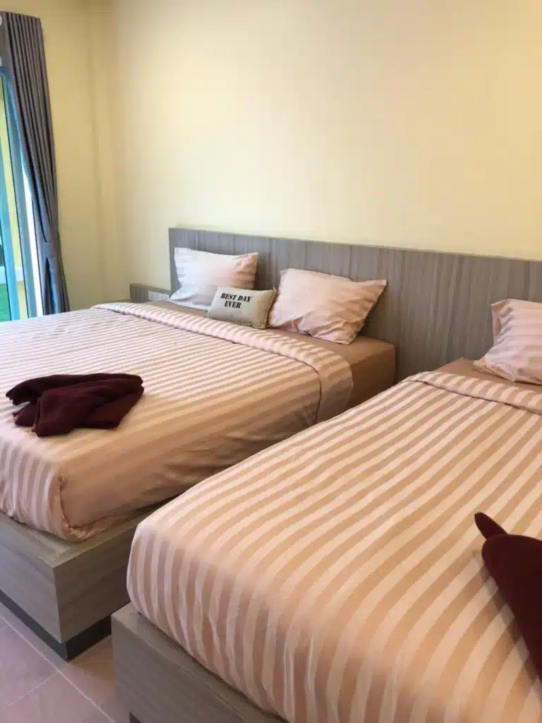 เตียงสองเตียงวางติดกันในห้องแห่งหนึ่ง ณ สถานที่ท่องเที่ยวในจังหวัดราชบุรี เกาะช้างที่พัก ประเทศไทย