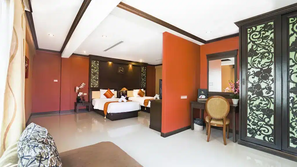 ห้องที่มีสองเตียงและผนังทาสีส้ม ที่พักอ่าวนางกระบี่ โรงแรมกระบี่อ่าวนาง