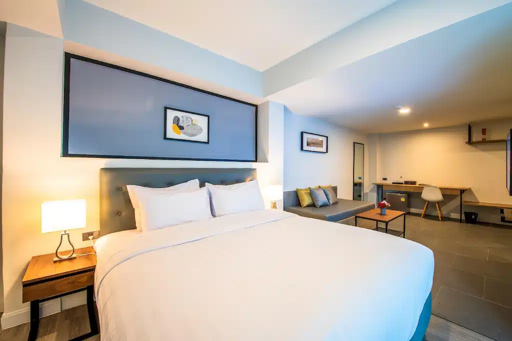 ห้องพักโรงแรมมีเตียงและโต๊ะตั้งอยู่ใกล้ๆระยอง. พระสมุทรเจดีย์