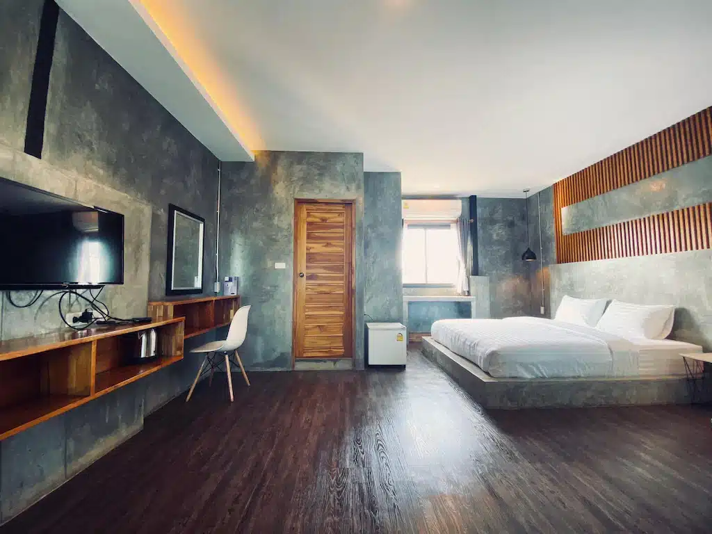 ห้องพักในโรงแรมที่มีพื้นไม้และเตียง ที่พักน่าน
