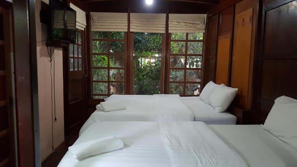 ที่พักราคาประหยัดพร้อมเตียง 2 เตียงปูด้วยผ้าปูที่นอนสีขาวภายในห้องไม้อันอบอุ่นสบาย ที่พักอัมพวาเปิดใหม่