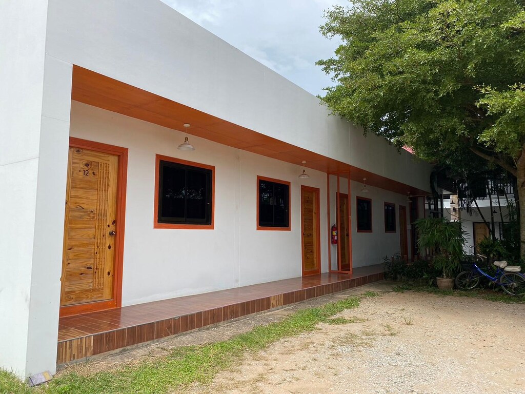 อาคารสีขาวที่มีประตูและหน้าต่างสีส้ม ภูชี้ฟ้าที่พัก