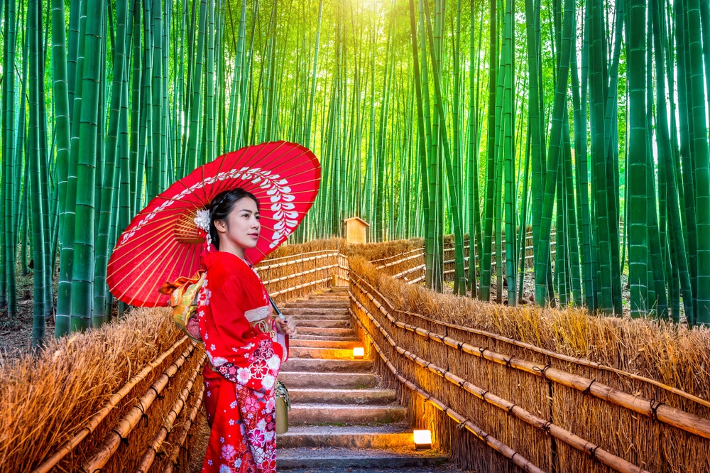 ผู้หญิงในชุดกิโมโนสีแดงกำลังสำรวจป่าไผ่ในราชบุรีที่เที่ยว ที่เที่ยวญี่ปุ่น