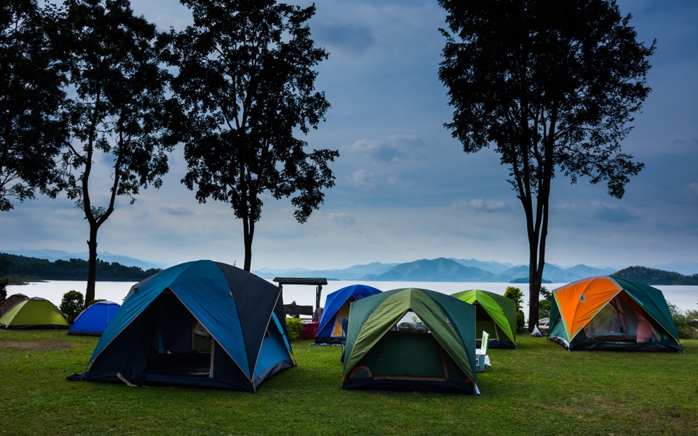 กางเต็นท์นอนบนสนามหญ้าใกล้ทะเลสาบมีภูเขาอยู่ไกลๆ ที่เที่ยวเดือนพฤษภาคม เหมาะกับที่เที่ยวเดือนพฤษภา