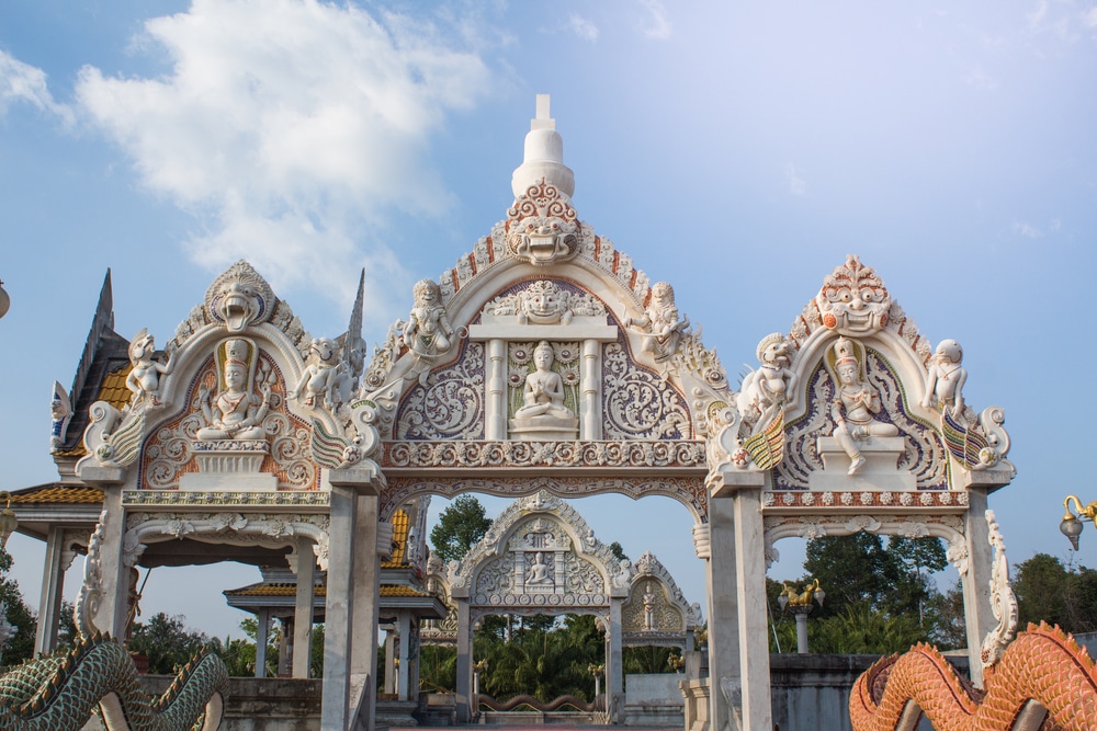 a ornate archway with statues on top