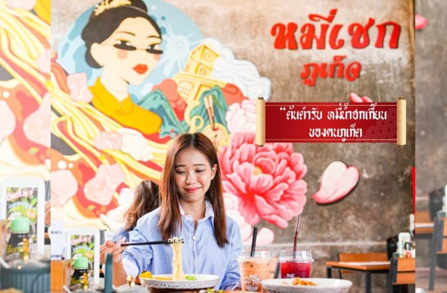 ผู้หญิงคนหนึ่งนั่งอยู่ที่โต๊ะร้านอาหาร มองดูชามบะหมี่ จิตรกรรมฝาผนังขนาดใหญ่สีสันสดใสเป็นรูปผู้หญิงแบบดั้งเดิมและมีคำว่า "คัมภีร์ข้าวมันไก่" ปรากฏอยู่บนผนังด้านหลังของเธอ