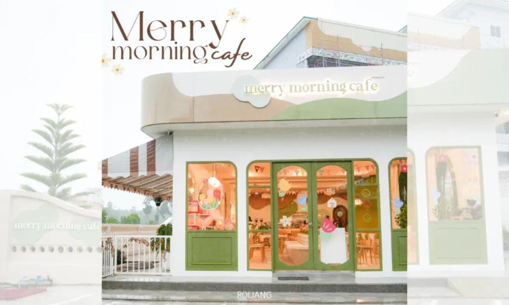ร้านกาแฟสีขาวและสีเขียวที่มีหน้าต่างบานใหญ่และป้ายเขียนว่า “Merry Morning Cafe” โดยมีคนยืนอยู่ที่ทางเข้า เชิญชวนแขกให้เริ่มต้นวันใหม่ในจุดร่าเริงนี้.