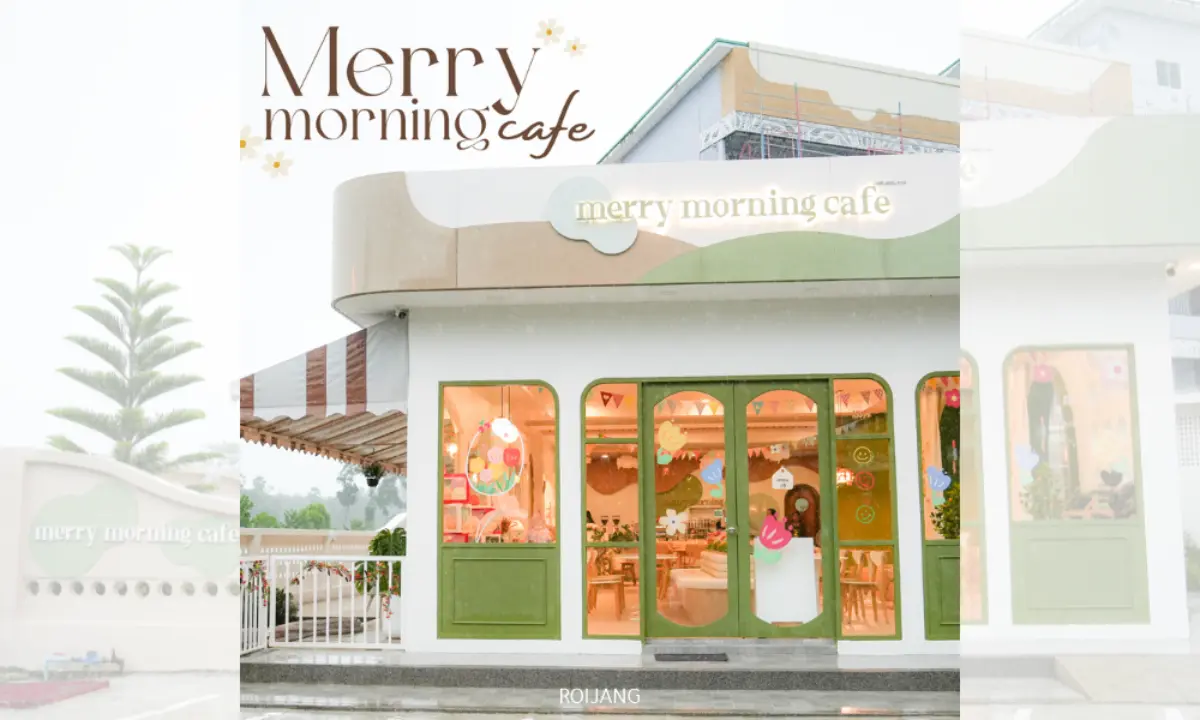 ร้านกาแฟสีขาวและสีเขียวที่มีหน้าต่างบานใหญ่และป้ายเขียนว่า “Merry Morning Cafe” โดยมีคนยืนอยู่ที่ทางเข้า เชิญชวนแขกให้เริ่มต้นวันใหม่ในจุดร่าเริงนี้.