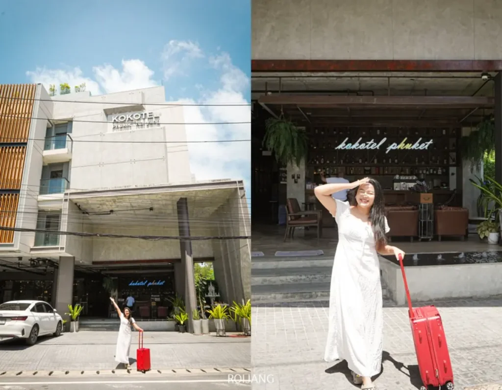 ผู้หญิงในชุดสีขาวพร้อมกระเป๋าเดินทางสีแดงยืนอยู่หน้ารีสอร์ท Kokotel Phuket โพสท่าและยิ้มอยู่หน้าร้านและตัวอาคาร ถ่ายทอดบรรยากาศแบบแอบแอในระหว่างการเดินทางของเธอ.